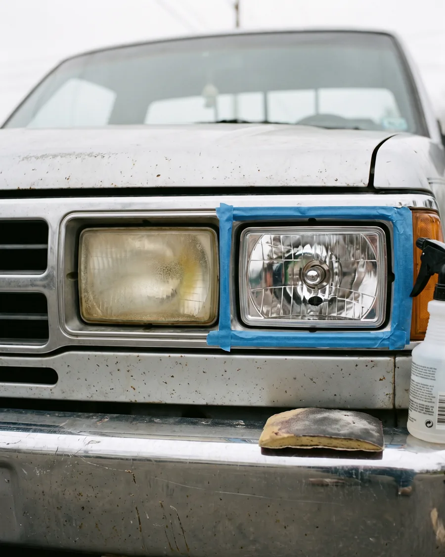 A silver pickup with one cloudy yellowed headlight and one restored clear headlight